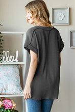 Woman in Heimish full size exposed seam short sleeve ribbed top and jeans
