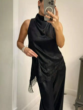 Black satin high neck cami dress with delicate lace trim along the hem featuring high neck lace detail
