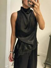 Black satin sleeveless high neck cami with delicate lace trim along the hem for elegant layering or formal wear