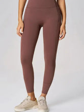 High waist active leggings in solid brown with side pockets and moderate stretch