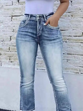 High waist bootcut jeans in faded blue denim with subtle distressing and a high waist design for stylish wear