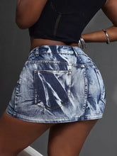 High waist denim mini skirt in faded blue wash with visible stitching details and a high-waisted fit