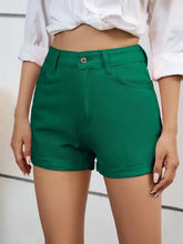Emerald green high waist denim shorts with button closure and front pockets