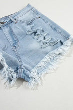 High waist denim shorts in light blue with distressed raw hem