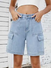 High waist denim shorts with cargo pockets and light wash fabric