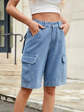 High waist denim shorts in light blue wash with cargo pockets