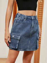 High waist denim skirt in blue with mid-waist cut, cargo pockets, and relaxed fit for casual wear