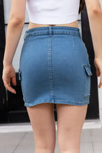 High waist pocketed denim skirt in blue featuring cargo pockets and a mini length in denim material