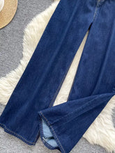 Dark blue denim high waist wide leg jeans with straight-leg cut and visible stitching details