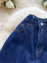High waist wide leg deep blue denim jeans with contrasting light stitching and silver button at the waistband
