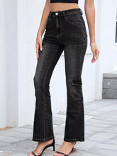 Black high-waisted bootcut jeans with patch pockets and a distressed finish shown from the back side