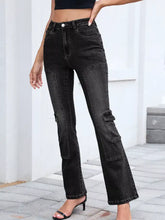 Black high-waisted bootcut denim jeans with cargo pockets and a flared leg for a stylish casual look