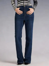 Dark blue high-waisted bootcut jeans in denim with a straight-leg cut and gold-tone button closure