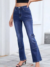 High-waisted bootcut dark blue denim jeans with cargo pockets designed for stylish casual wear