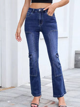 Dark blue high waisted bootcut jeans made of denim with cargo pockets on the thighs