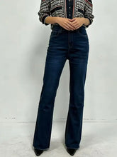 Dark blue high-waisted bootcut jeans made of denim with frayed hems and a flattering flare design