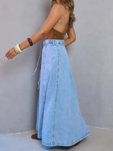 Light blue high-waisted denim skirt with maxi length and side drawstring detail in soft denim fabric