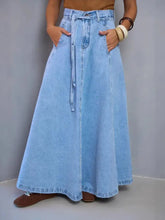 Light blue high-waisted denim skirt with drawstring waist and front pockets made from denim material