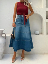 High-waisted denim skirt in blue with red fabric tie and horizontal seams machine wash safe mid-thigh length denim skirt