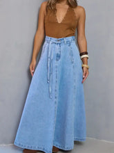 Light blue high-waisted denim skirt with maxi length and tie belt made from denim material