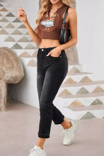 Black high-waisted cropped distressed hem straight leg jeans with button closures and rolled cuffs