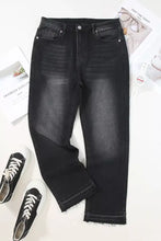 High-waisted black denim jeans with a slightly faded wash and distressed hem straight leg for a modern look