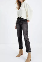 High-waisted dark wash denim jeans with a distressed hem straight leg cut and rolled cuffs