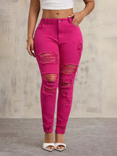 Fuchsia high-waisted distressed skinny jeans with slim fit ripped design and frayed edges