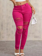 Fuchsia high-waisted distressed skinny jeans with frayed edges and slim fit in soft denim material