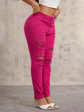 Fuchsia high-waisted distressed skinny jeans with ripped details on a high-rise fit, shown from the back side