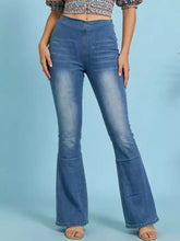 Blue denim high-waisted flare jeans with subtle fading and a tape measure for accurate sizing