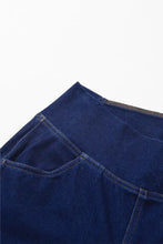 Dark blue high-waisted flare jeans made of denim fabric with visible stitching and zipper detail for a perfect fit