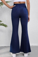 Dark blue high-waisted flare jeans made of denim with classic back pocket design for a perfect fit back view