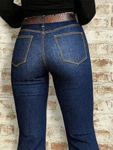 High-waisted dark blue denim flare jeans with moderate stretch and contrasting light brown stitching and patterned belt