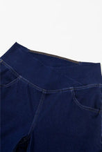 Dark blue denim high-waisted flare jeans with front pockets designed for maternity wear and comfort