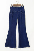 Dark blue denim high-waisted flare jeans with front pockets featuring a stylish flare jeans design