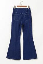 Dark blue denim high-waisted flare jeans showing the back side with two pockets for a stylish fit