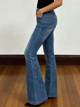 High-waisted medium-wash blue denim flare jeans with classic five-pocket design and tape measure for sizing accuracy