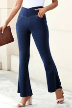 Navy blue high-waisted flare jeans with stretchy waistband and side pockets made from comfortable fabric