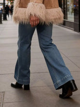 Blue denim high-waisted flare leg jeans showcasing a classic flare leg silhouette in durable cotton material