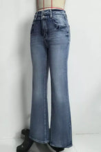 High-waisted flare leg jeans in faded blue denim with a soft wash recommend measuring for perfect fit