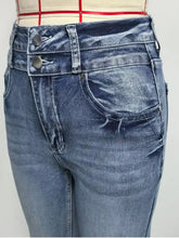 High-waisted flare leg denim jeans with faded blue wash and double-button front closure recommend measuring for fit