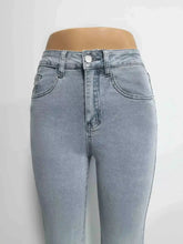 Light-wash denim high-waisted flare jeans with high-rise skinny fit, classic five-pocket design, and white button closure