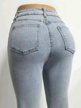Light-wash denim high-waisted flare jeans with a fitted silhouette and classic back pockets shown from the back side