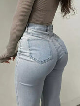 Light-wash high-waisted flare jeans with slim fit and classic back pockets shown from the back side