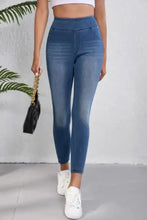 High-waisted skinny jeans in blue denim with slim fit and subtle fading designed as high-waisted skinny leggings