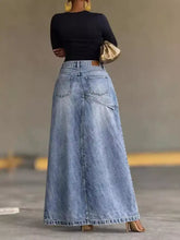 A light-wash high-waisted slit denim skirt with classic five-pocket design and straight hemline for stylish wear