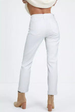 White high-waisted straight leg jeans with frayed hem and classic back pockets shown from the back side