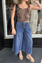 Blue denim high-waisted wide leg button-fly jeans with front button closure and wide leg silhouette