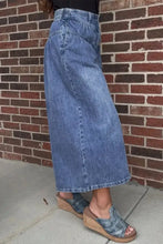 High-waisted mid-blue denim skirt with straight cut and frayed hem styled with wide leg button-fly jeans
